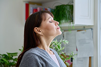 Person inhaling clean air after Freehold duct service