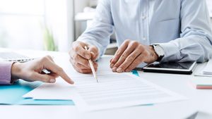 NJ ITM maintenance contracts being signed at a desk