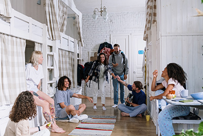 Ocean County custom home builders show how bunk beds can work for kids and adults with this picture showing a room full of adults hanging out around bunk beds